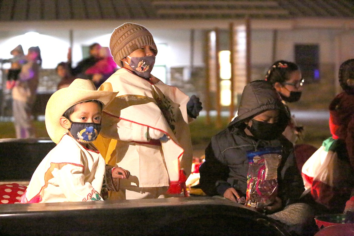 A pair of vaqueros toss candy to the kids in the Christmas in the Park parade Friday in Mattawa.