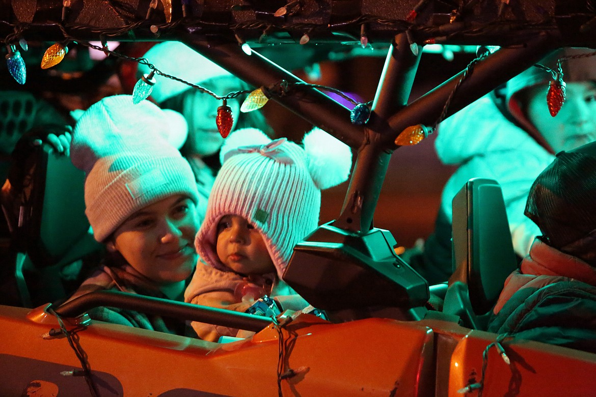 Well-bundled riders survey the crowd during the Christmas in the Park parade Friday in Mattawa.