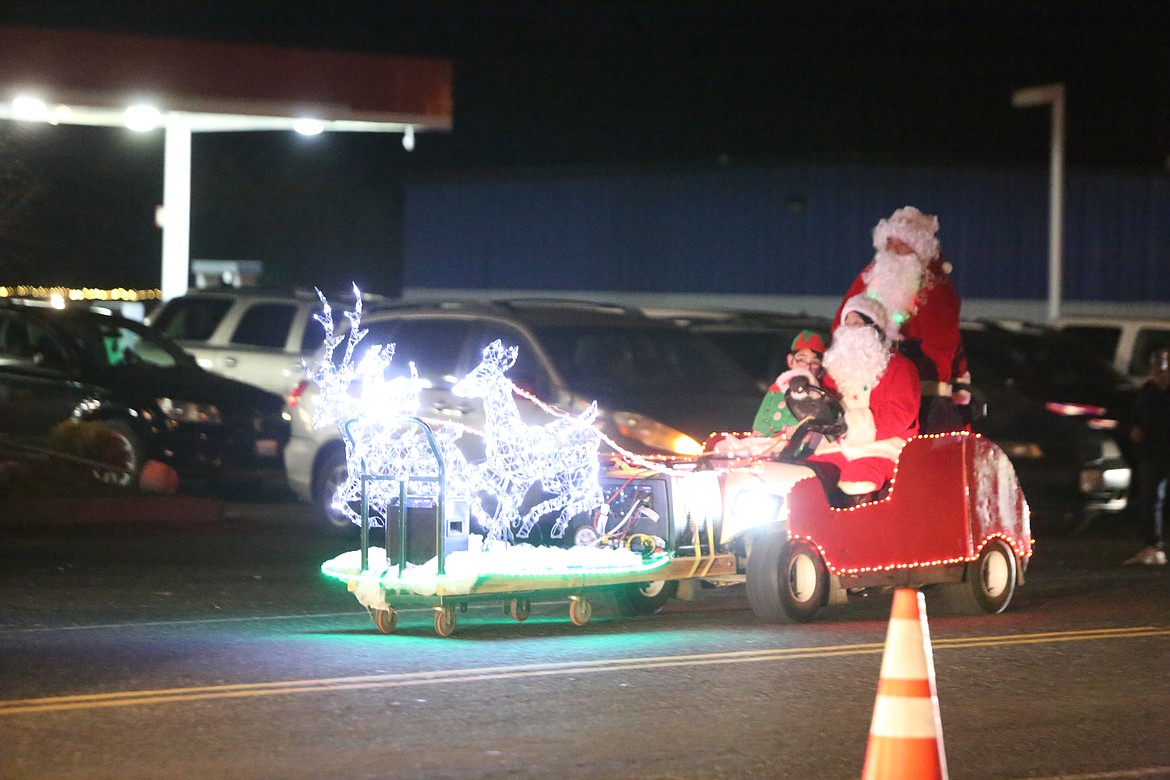 Multiple Santas and the reindeer head back to the barn after the Christmas in the Park parade Friday in Mattawa.