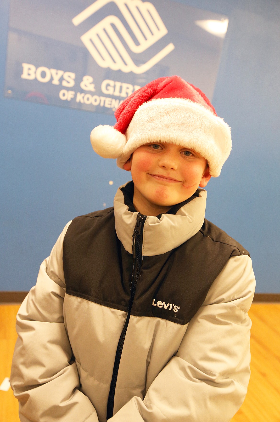 Savior Taylor shows off the new coat he received Tuesday at the Lola & Duane Hagadone Boys & Girls Club.