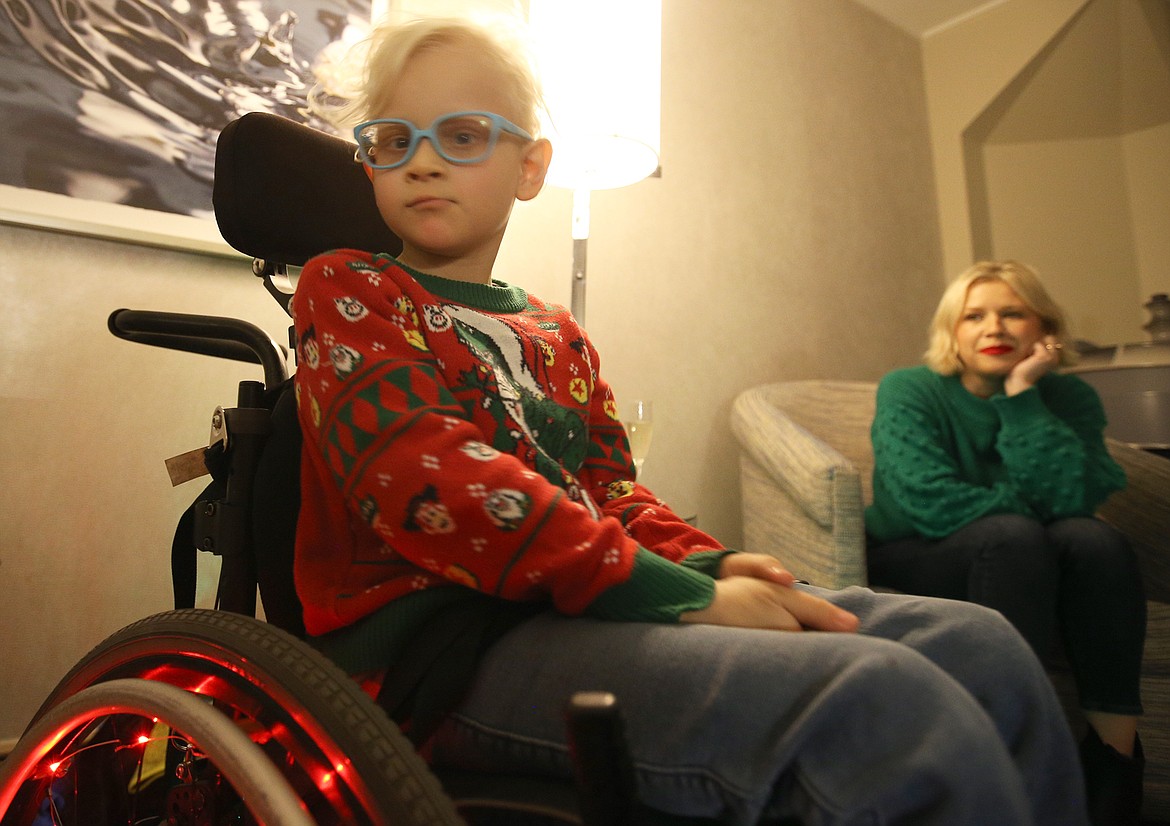 Ford Parks looks at a visitor as his mom sits nearby at The Coeur d'Alene Resort on Saturday.