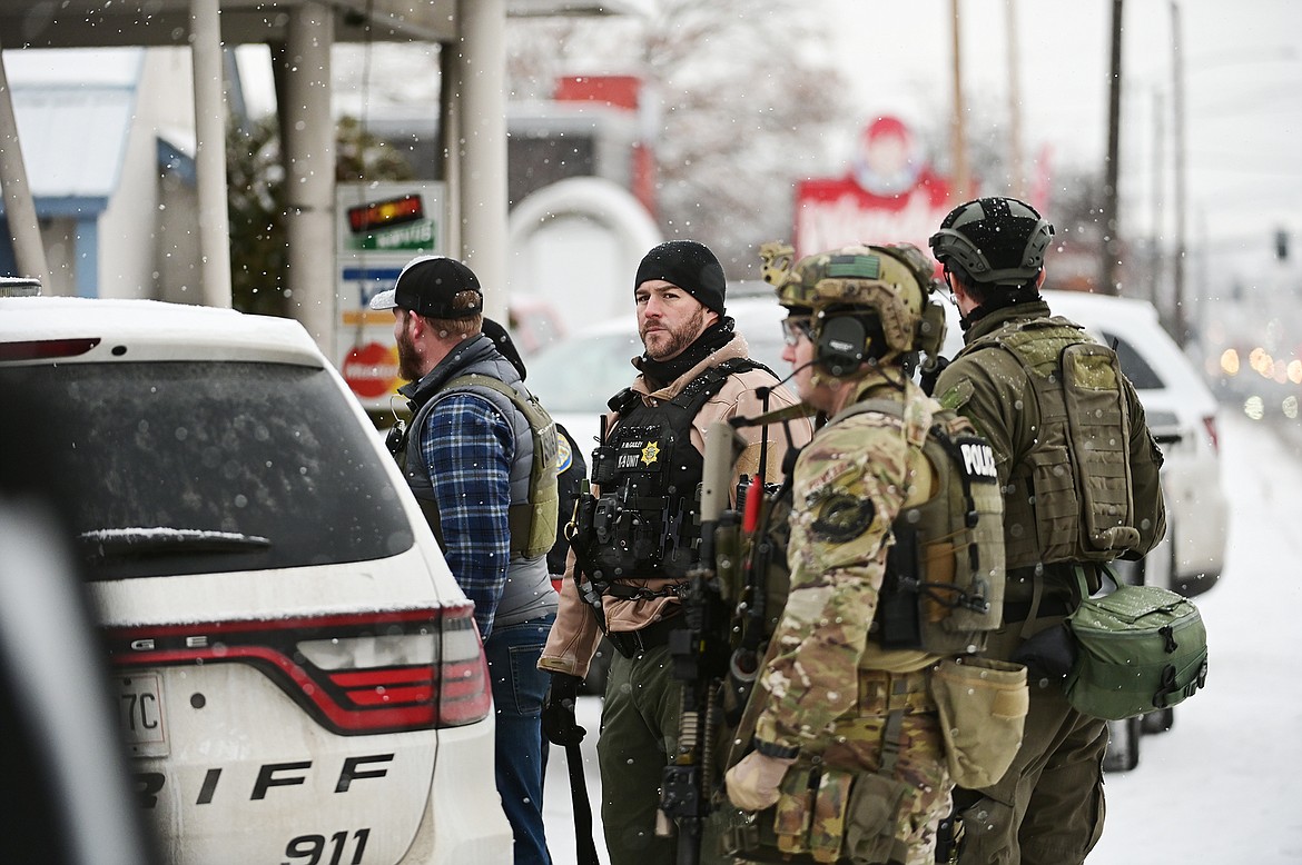 Law enforcement personnel stand at the scene of a standoff at the Blue & White Motel in Kalispell on Thursday, Dec. 16. (Casey Kreider/Daily Inter Lake)