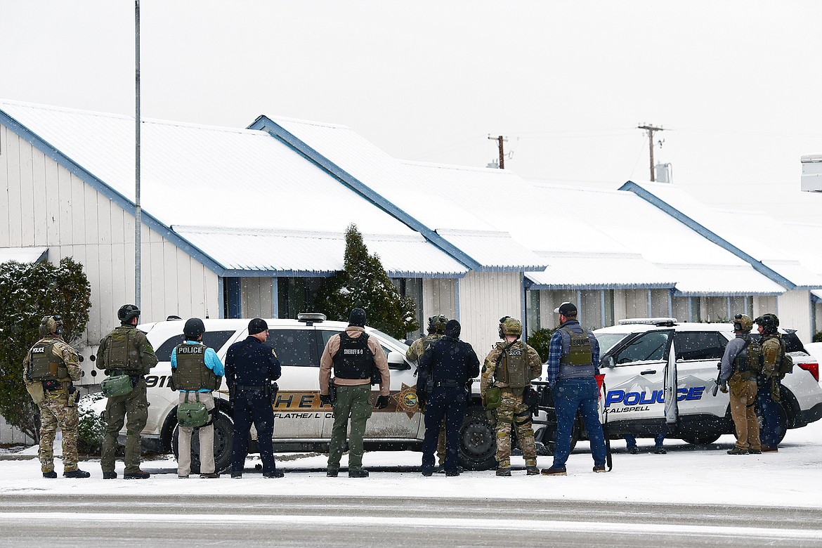 Law enforcement personnel stand at the scene of a standoff at the Blue & White Motel in Kalispell on Thursday, Dec. 16. (Casey Kreider/Daily Inter Lake)