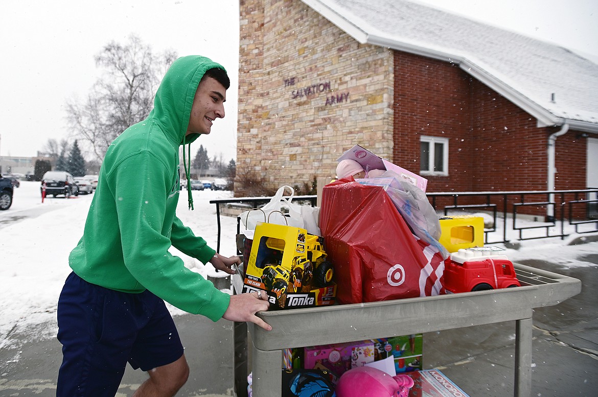 Glacier High School senior Thomas Putnam wheels a cart full of gifts donated by fellow students and staff to The Salvation Army for their Angel Tree Program on Thursday, Dec. 16. The program helps provide Christmas gifts to hundreds of thousands of children around the country each year. Glacier students and staff donated around 300 gifts for local children. (Casey Kreider/Daily Inter Lake)