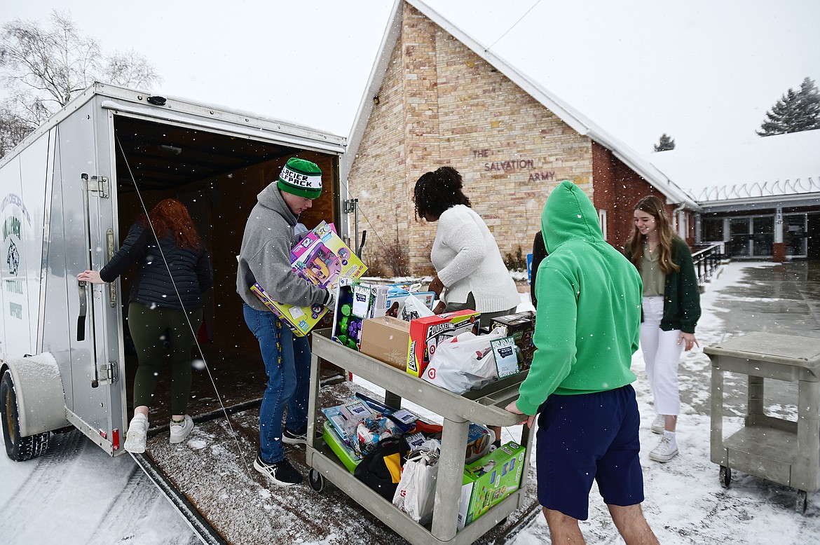 Glacier High School students unload a trailer stocked with gifts donated by fellow students and staff to The Salvation Army for their Angel Tree Program on Thursday, Dec. 16. The program helps provide Christmas gifts to hundreds of thousands of children around the country each year. Glacier students and staff donated around 300 gifts for local children. (Casey Kreider/Daily Inter Lake)