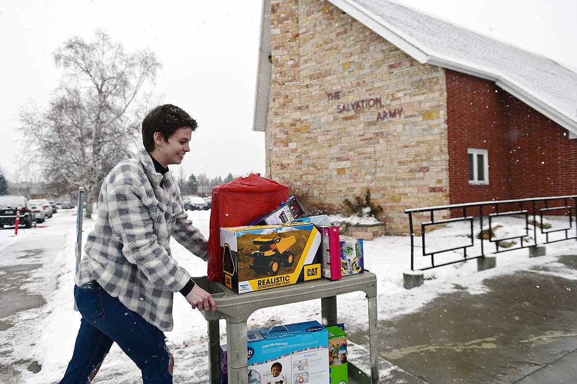 Glacier High School senior Jordan Reiner wheels a cart full of gifts donated by fellow students and staff to The Salvation Army for their Angel Tree Program on Thursday, Dec. 16. The program helps provide Christmas gifts to hundreds of thousands of children around the country each year. Glacier students and staff donated around 300 gifts for local children. (Casey Kreider/Daily Inter Lake)