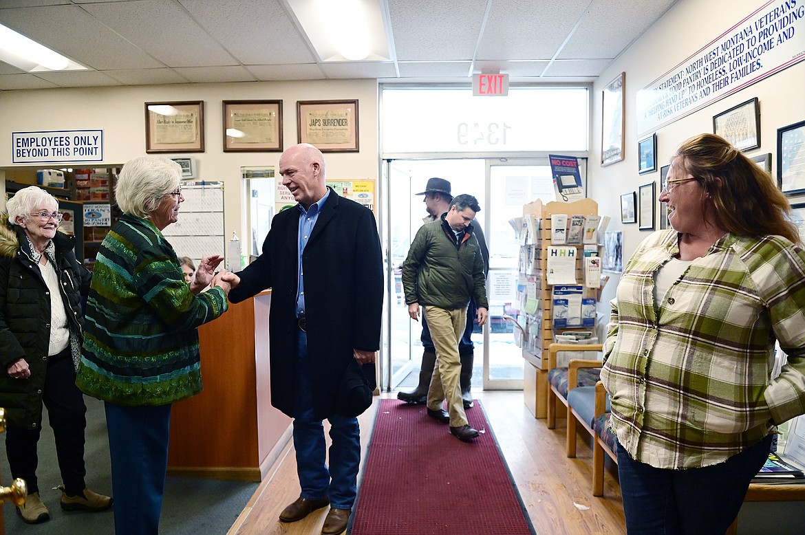 Gov. Greg Gianforte greets Linda Erickson as he arrives for a tour and to volunteer at the Northwest Montana Veterans Stand Down and Food Pantry in Evergreen as part of his 12 Days of Giving  campaign on Thursday, Dec. 16. (Casey Kreider/Daily Inter Lake)