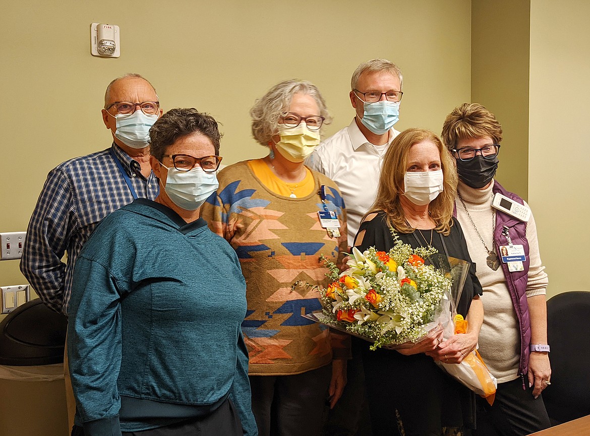 Terri Dunn, in front holding flowers, is joined by Joe Schmier, Heather Murray, Jeny Covill, Dr. Jonathan Amick and Kathy Emerson while accepting the Logan Health — Whitefish Planetree Caregiver of the Year award. (Courtesy photo)