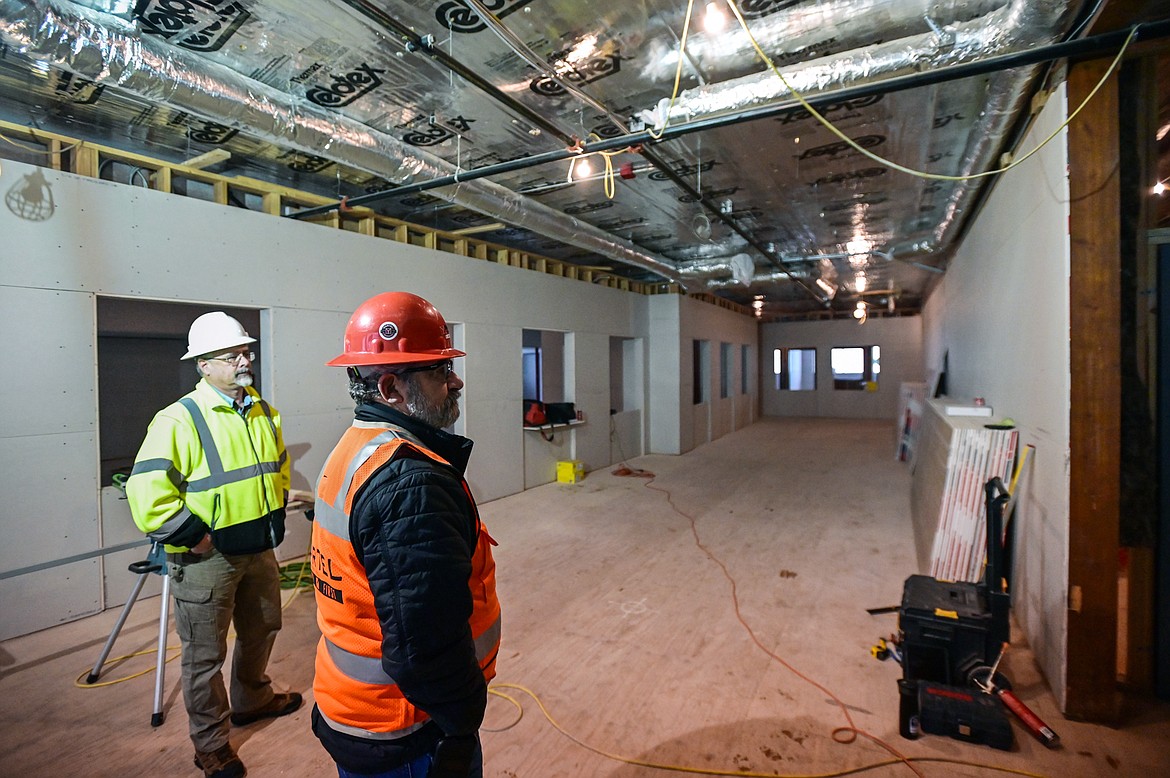 David Covill, left, building maintenance manager for Flathead County, and Larry Palmer, project superintendant with Martel Construction, give a tour of the future offices in the county's North Campus Building in Kalispell on Thursday, Dec. 16. (Casey Kreider/Daily Inter Lake)