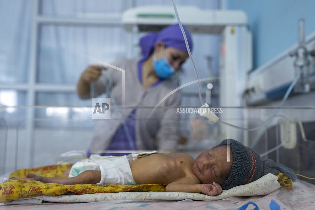 A nurse takes care of a baby in the neonatal intensive care unit of Malalai Maternity hospital in Kabul Afghanistan, on Thursday, Dec. 9, 2021. Afghanistan's health care system, is on the brink of collapse and to function only with a lifeline from aid organisations. (AP Photo/ Petros Giannakouris)