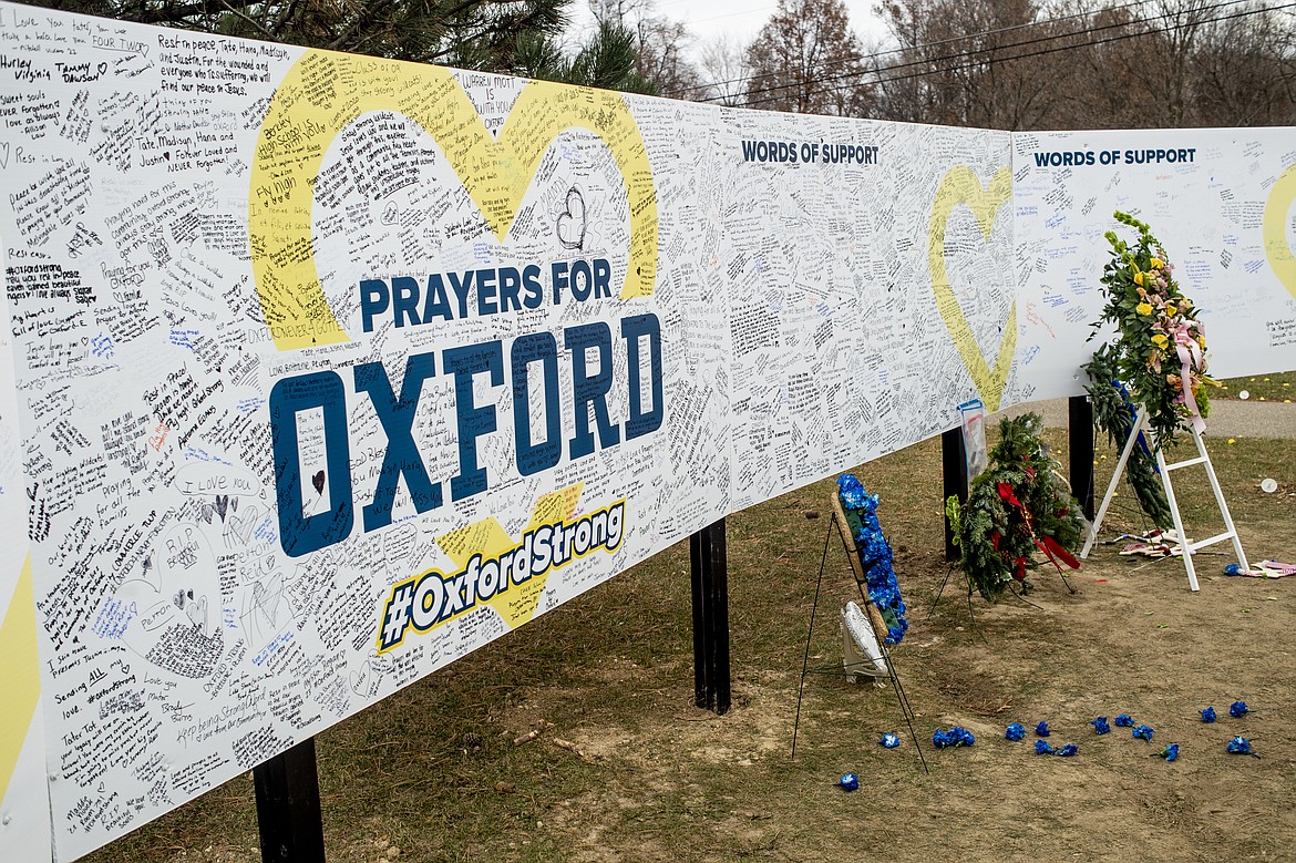 FILE - Handwritten messages are left at the memorial site at the memorial site on Tuesday, Dec. 7, 2021, outside Oxford High School in Oxford, Mich., after a 15-year-old allegedly killed these four classmates, and injured seven others in a shooting inside the northern Oakland County school one week earlier. School officials around the country are planning to step up security Friday in response to social media posts warning of violence. The anonymous threats on TikTok had many educators on edge because they are circulating in the aftermath of a deadly school shooting in Michigan. (Jake May/The Flint Journal via AP, File)