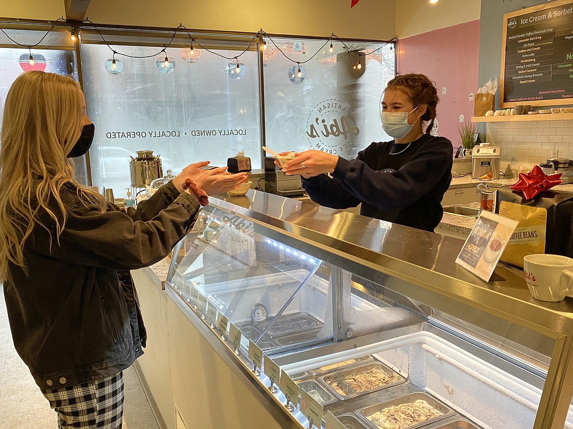 On a snowy Thursday afternoon, Abi's Artisan Ice Cream sales are still going strong. Employee Kate Hoopman, who has been with the company for two years, hands a scoop to customer Clarissa Marsh.