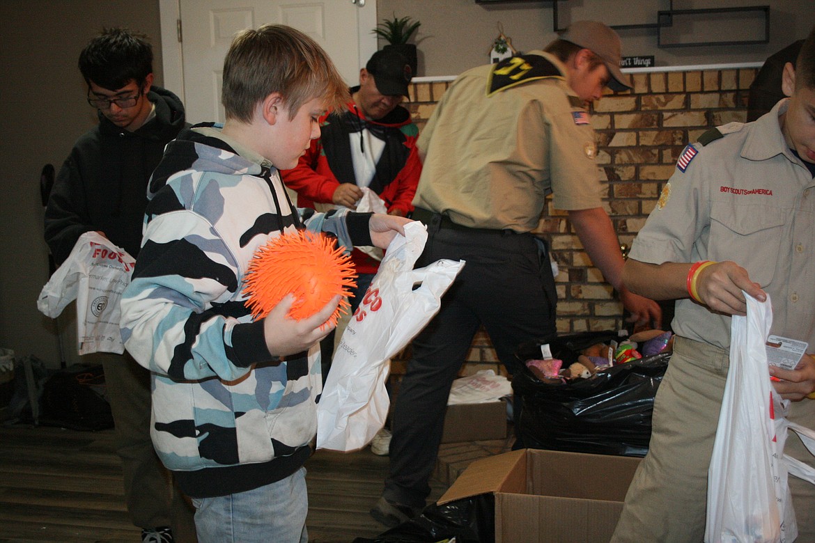 Scout Troop 777 member Jared Tebow separates donated toys for distribution through the Christmas Toy Giveaway.