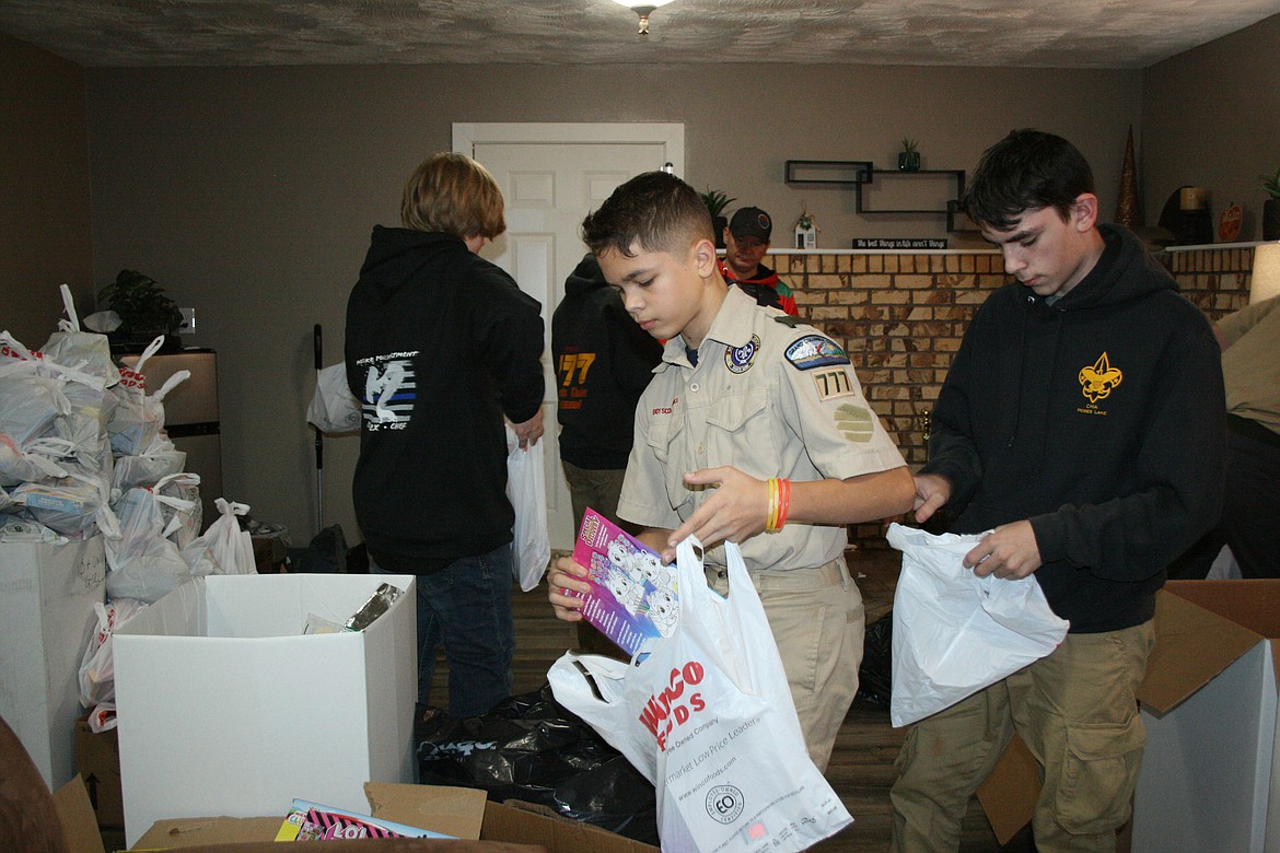 Scout Troop 777 members Connor Leland (left) and Chance Morris (right) sort toys.
