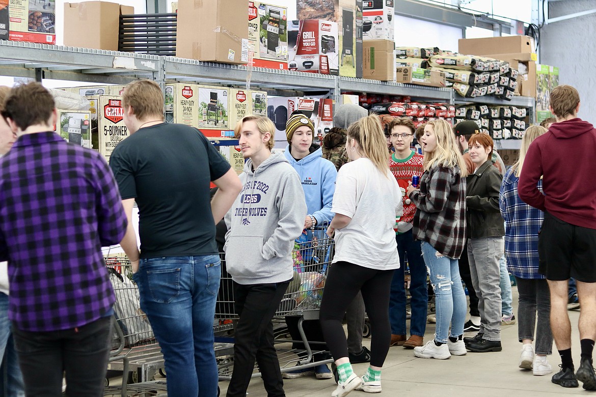 Students in Lake City High School teacher Matt Ruchti's economics class raised over $7,000 to purchase food and gifts at the Walmart in Hayden on Wednesday morning for individuals and families through Family Promise and the Union Gospel Mission in Coeur d'Alene. HANNAH NEFF/Press