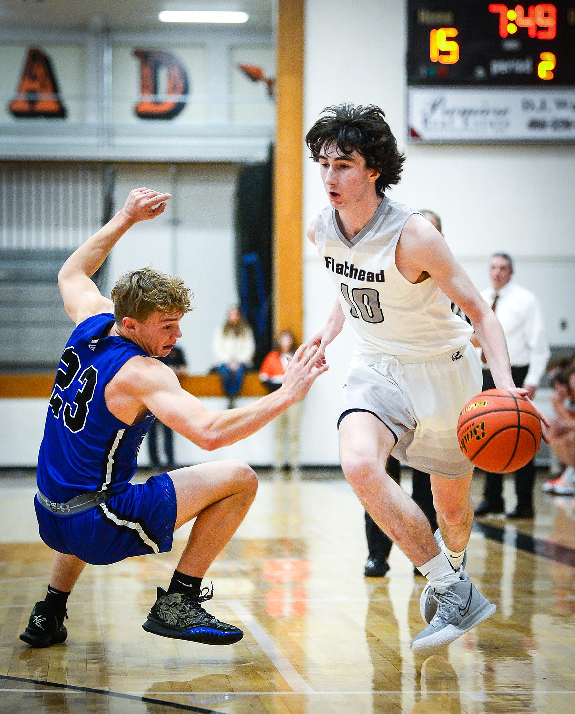 Flathead's Noah Cummings (10) dribbles past Gallatin defender Noah Pickard (23) in the first half at Flathead High School on Friday, Dec. 17. (Casey Kreider/Daily Inter Lake)