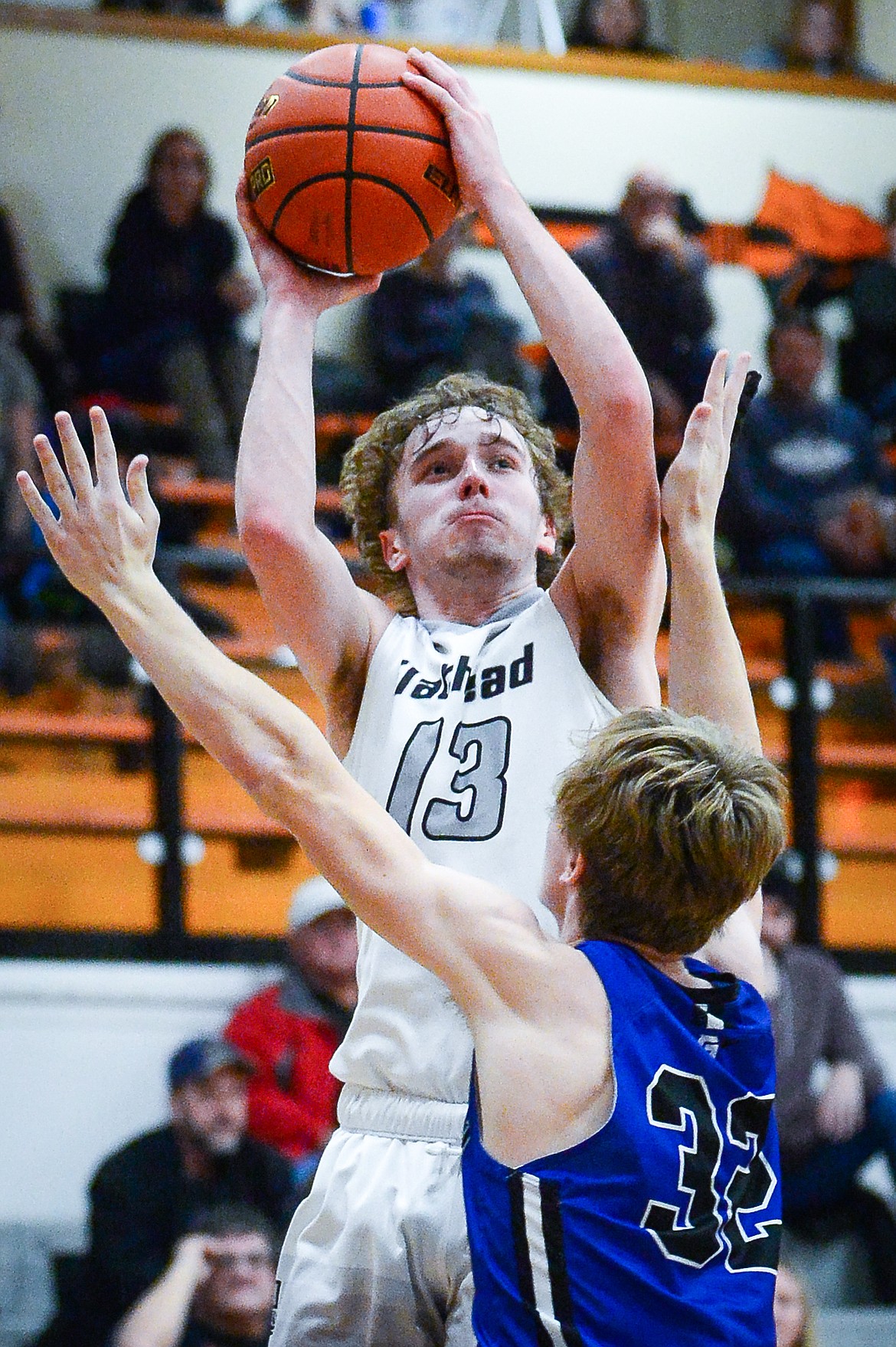 Flathead's Gavin Chouinard (13) drives to the basket against Gallatin's Tyler Nansel (32) at Flathead High School on Friday, Dec. 17. (Casey Kreider/Daily Inter Lake)