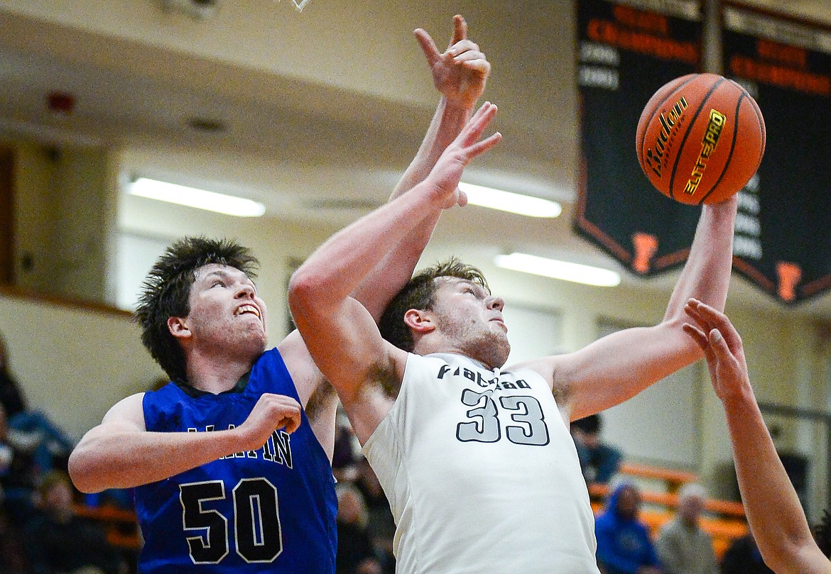 Flathead's Joe Hansen (33) grabs a rebound over Gallatin's Rylan Schlepp (50) in the first half at Flathead High School on Friday, Dec. 17. (Casey Kreider/Daily Inter Lake)