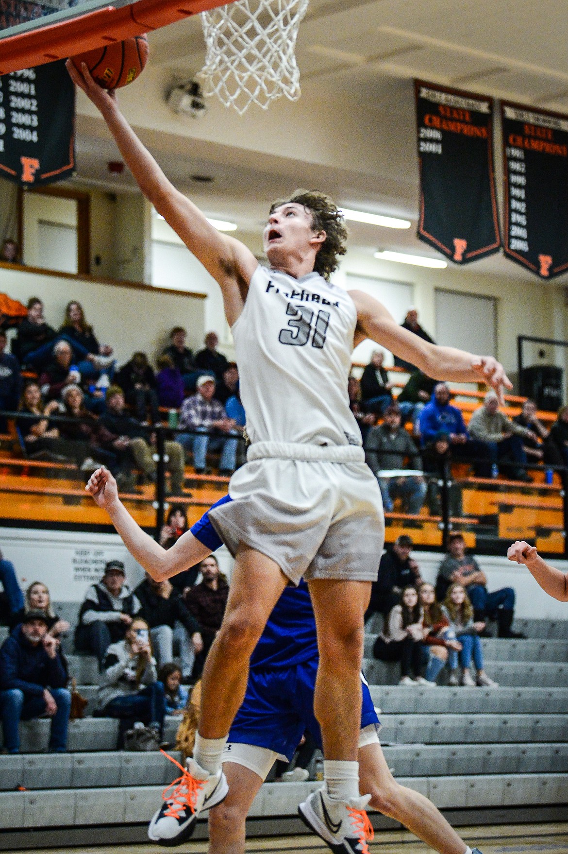 Flathead's Lyric Ersland (31) drives to the basket past Gallatin's Eli Hunter (3) in the first half at Flathead High School on Friday, Dec. 17. (Casey Kreider/Daily Inter Lake)