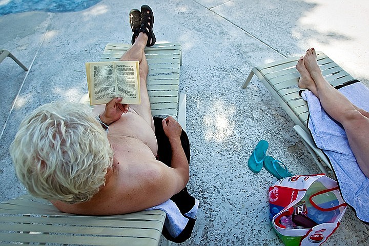 A couple relax by the pool with a book while visiting Sun Meadow. JEROME POLLOS/Press file