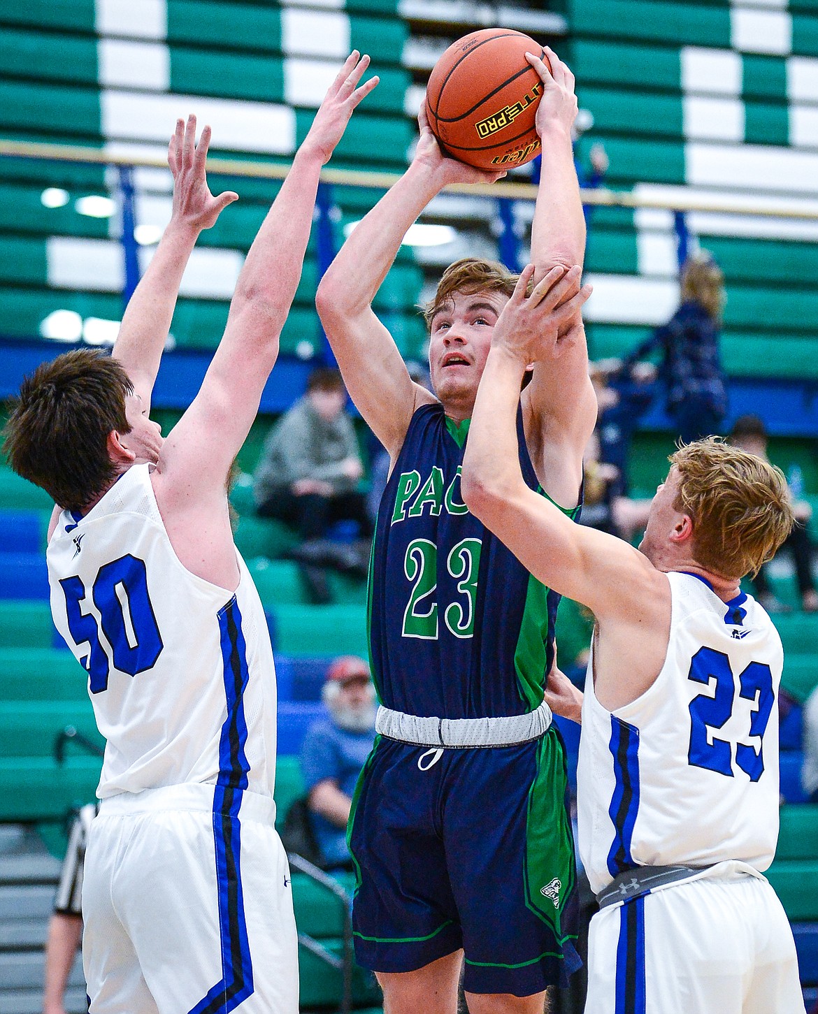 Glacier's Will Salonen (23) looks to shoot over Gallatin's Rylan Schlepp (50) and Noah Pickard (23) at Glacier High School on Saturday, Dec. 18. (Casey Kreider/Daily Inter Lake)