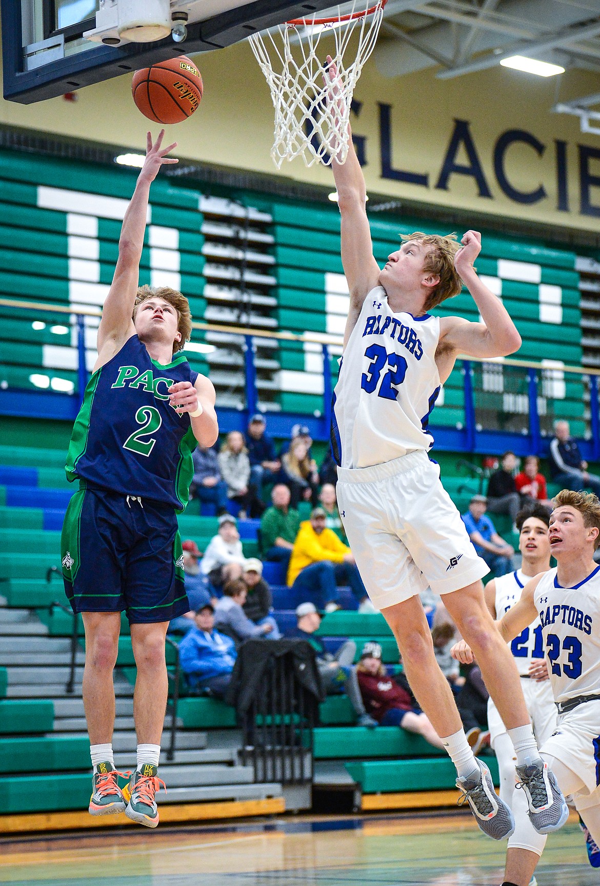 Glacier's Connor Sullivan (2) drives to the basket against Gallatin's Tyler Nansel (32) in the first half at Glacier High School on Saturday, Dec. 18. (Casey Kreider/Daily Inter Lake)