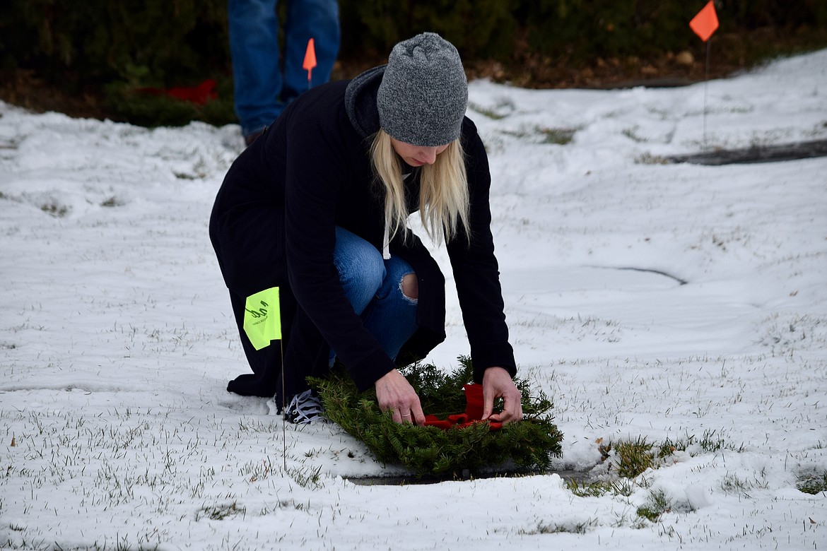 Othello resident Carrie Redding lays a wreath on a veteran’s grave in the Ephrata Cemetery on Saturday during the Civil Air Patrol’s Columbia Basin Composite Squadron annual Wreaths Across America ceremony.