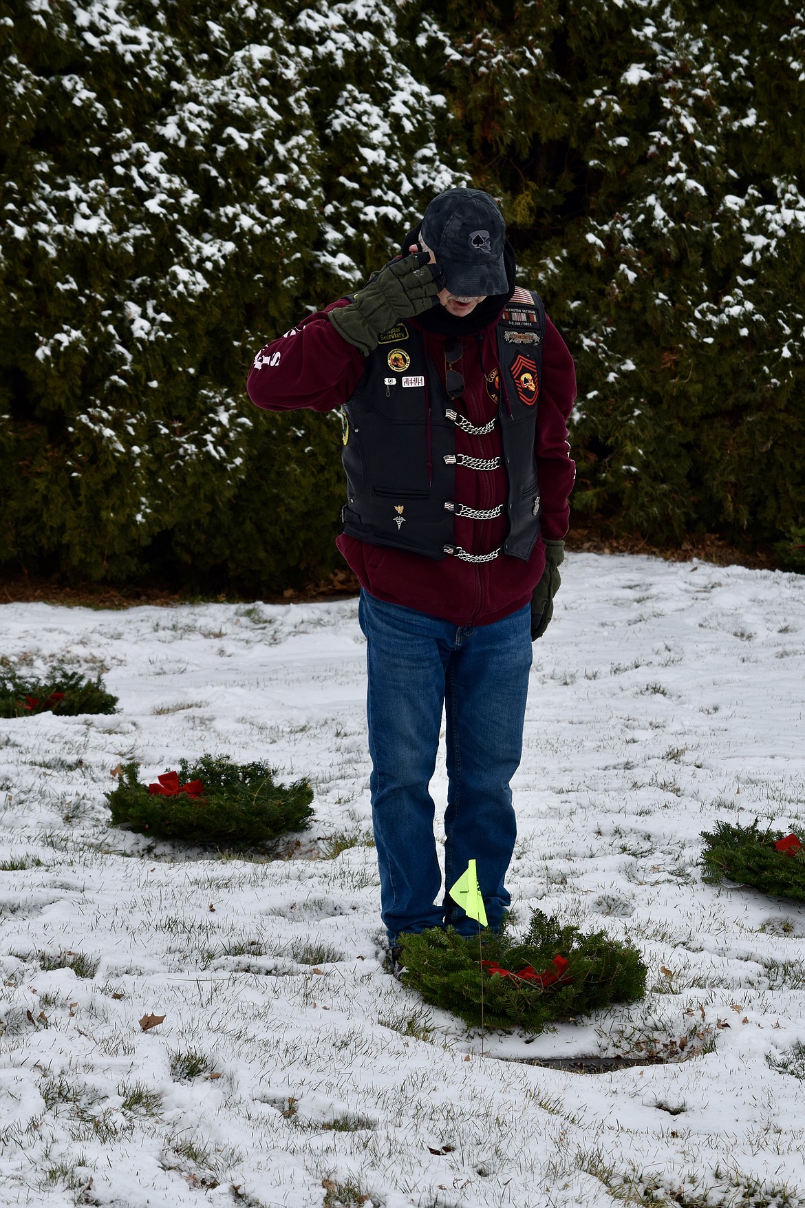 Retired U.S. Air Force Chief Master Sgt. Michael Hashberger with both the Civil Air Patrol and the Combat Veterans Motorcycle Association salutes the grave of a veteran in the Ephrata Cemetery as part of the Wreaths Across America ceremony on Saturday.