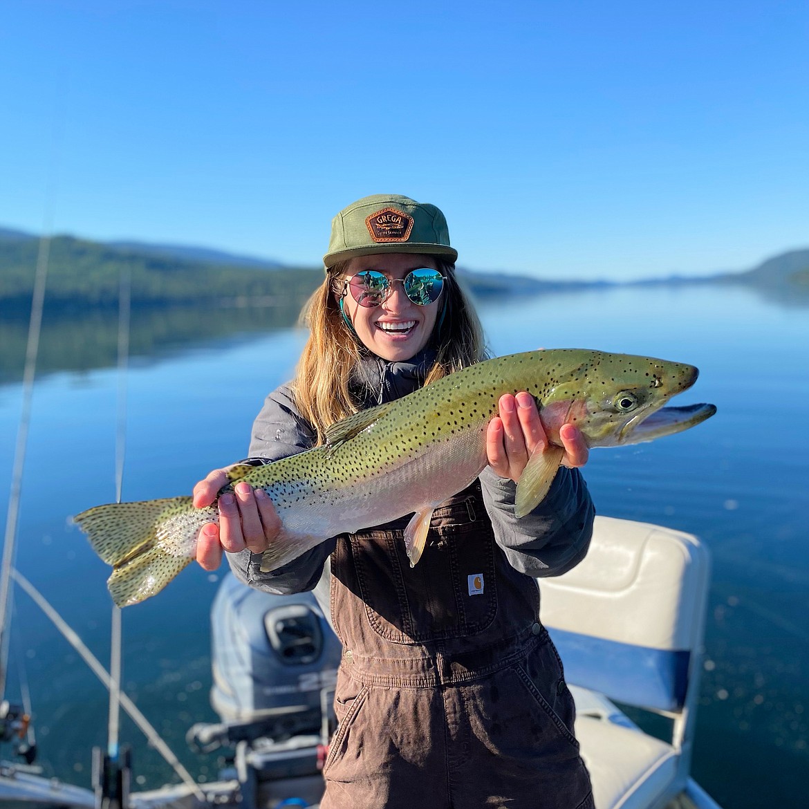 Madison Nackos of Spokane hoists a 24-inch Westslope cutthroat trout she hooked from Priest Lake, securing a new catch-and-release state record. The catch was recognized by Idaho Fish & Game officials as one of the state's top fish stories of 2021.