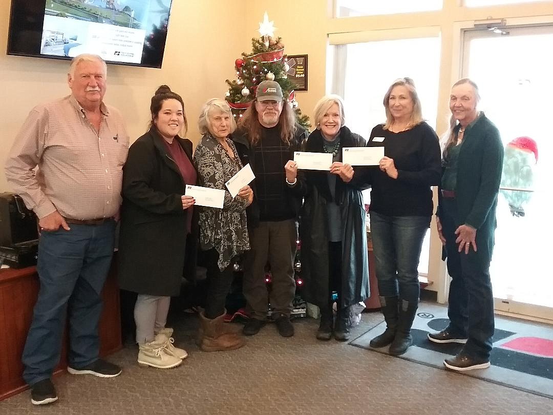In a commitment to give back to the community, the Kootenai/Shoshone Farm Bureau during its monthly meeting on Dec. 16 gave a total of $10,000 to local organizations. Those receiving $1,000 each were: Post Falls Food Bank, ABC (Athol) Food Bank, Spirit Lake Food Bank, Harrison Food Bank, Community Action Partnership-Coeur d'Alene, Rathdrum Food Bank, Shoshone Co. Food Bank, Children’s Village, Union Gospel Mission-Coeur d'Alene and 
Christmas For All. Kootenai/Shoshone Farm Bureau is an organization of agricultural producers and local citizens focused on providing a voice for Idaho agriculture and working for the betterment and higher awareness of food production. Taken on Dec. 16 at the Farm Bureau office in Dalton Gardens (from left): Joe Dobson, Kootenai Farm Bureau president; Emily Aizawa, Children’s Village; Charlotte Hooper, ABC Food Bank; Darrell Rickard, Community Action Partnership; Linda Cook, Union Gospel Mission; Leslie Orth, Post Falls Food Bank; and Linda Rider, Kootenai Farm Bureau Board secretary.