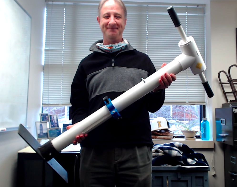 Dr. Matthew Swenson with the University of Idaho engineering department holds a prototype developed by university students that is based on the "Tree Cannon" design invented by thirteen-year-old North Idaho STEM Charter Academy student Sam Wilson.