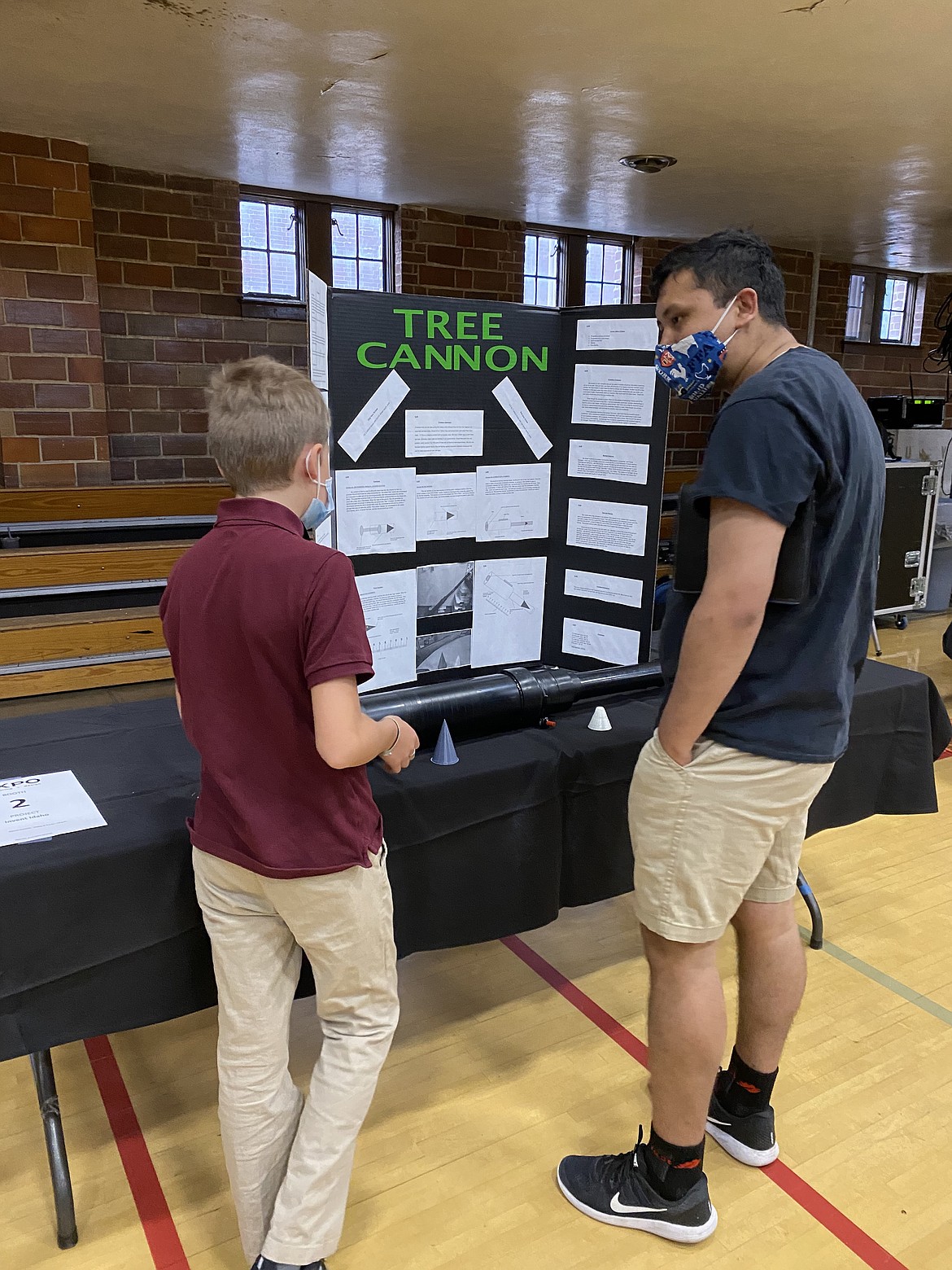 Thirteen-year-old inventor Sam Wilson explains his Tree Cannon idea to University of Idaho undergraduate students at a recent engineering expo.