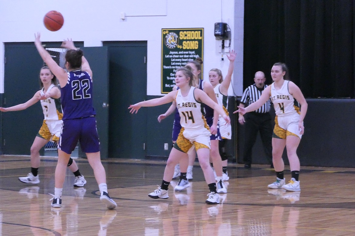 St. Regis senior Taylor Hurd  (14) watches as Charlo's Mila Hawk (22) passes to a teammate during Friday night's game in St. Regis.  (Chuck Bandel/Valley Press)