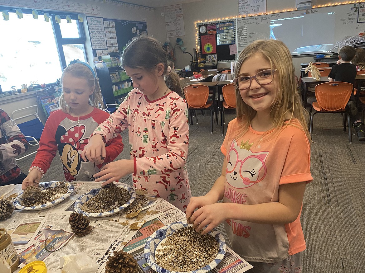 Treaty Rock third-grade students create a little gift to offer the birds outside. From left: Lexie Bainter, 8, Makena Bryson, 8 and Aurora Tarman, 8. "I'm surprised about how fast they can fly," Tarman said.