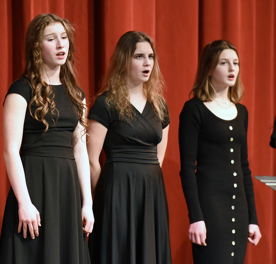 Whitefish High School choir members Hanna Gawe, Marina Nugent and Ava Bee sing as part of the Treble Choir recently during Whitefish Schools choir winter concert at the Whitefish Performing Arts Center. (Heidi Desch/Whitefish Pilot)