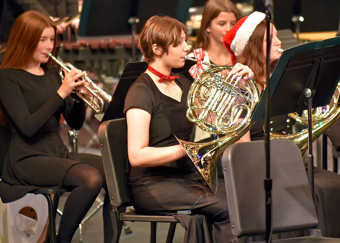 WHS french horn players Sophia Rendahl and Kira Raines, with eighth grader Tilly Daniels on the trumpet, perform during the Whitefish Bands Winter Concert on Dec. 9 at the Whitefish Performing Arts Center. (Whitney England/Whitefish Pilot)