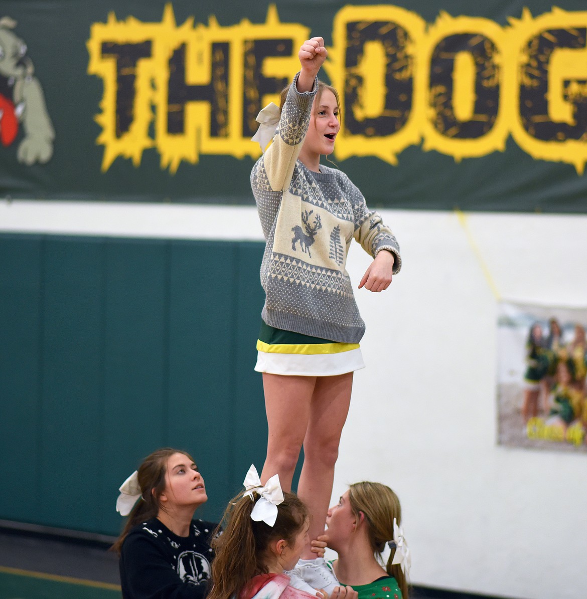 Whitefish cheerleader Lucy Olson leads a cheer, with support from Alie Simpson, Hanna Gawe and Ashlyn Morse, at a recent basketball game at Whitefish High School. (Whitney England/Whitefish Pilot)