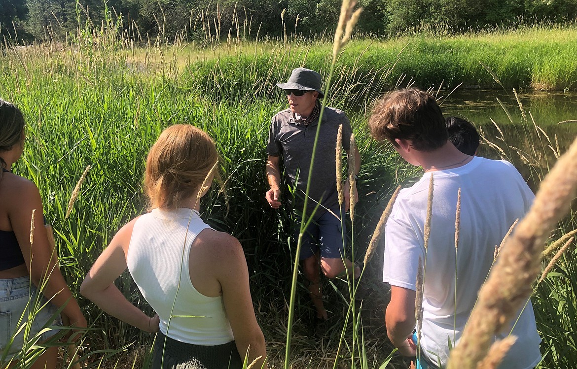 Coeur d’Alene Tribe water resources specialist Ben Scofield talks to interns about native and invasive wetland plants.