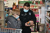 Shopping with a purpose: Kids, local law enforcement officers take carts through store aisles in search of gifts