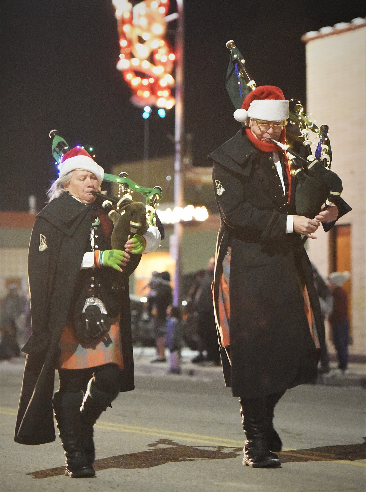 Bagpipers march and play during the 2021 Ronan Parade of Lights down Main Street. (Scot Heisel/Lake County Leader)