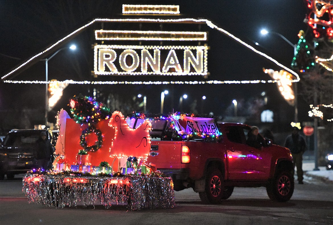 The St. Luke float turns in front of the new Ronan sign Friday night during the Parade of Lights. (Scot Heisel/Lake County Leader)