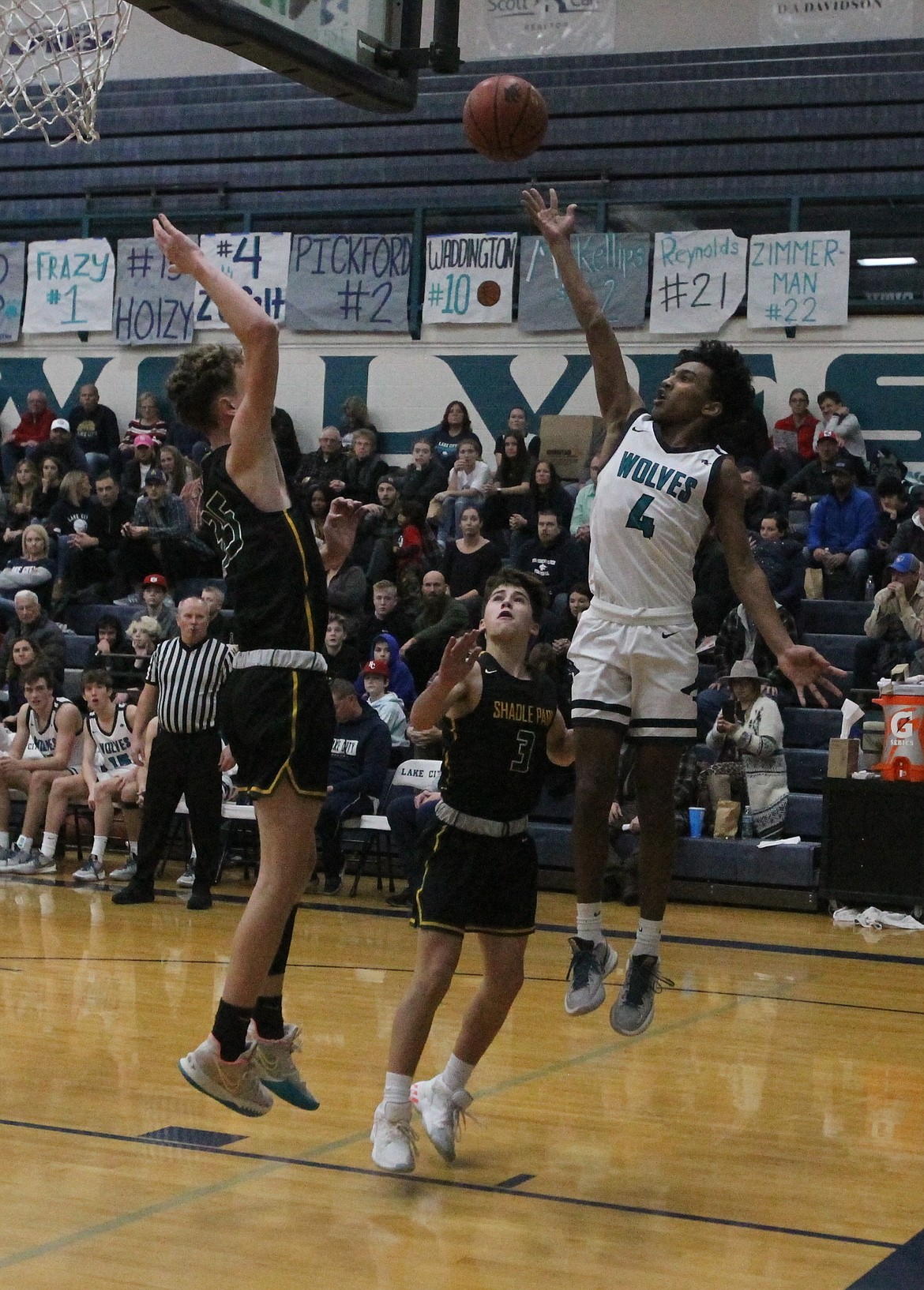 MARK NELKE/Press
Lake City freshman Cason Miller (4) shoots a runner along the baseline during the second half against Shadle Park on Tuesday night.