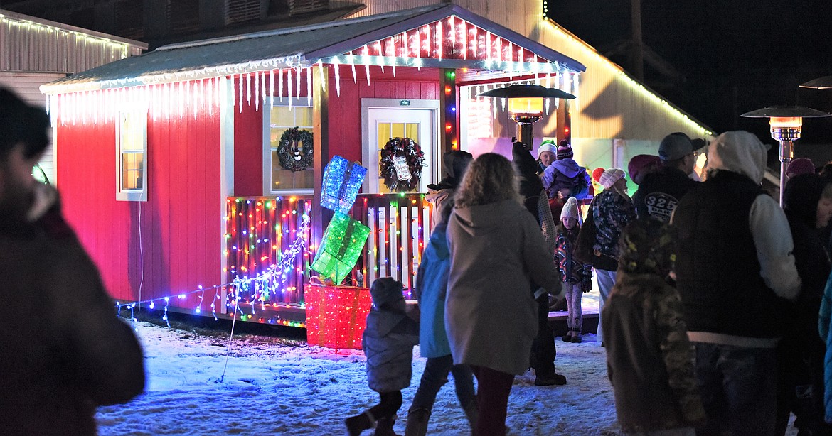 Children lined up for a chance to visit Santa inside his well lit house. (Scot Heisel/Lake County Leader)