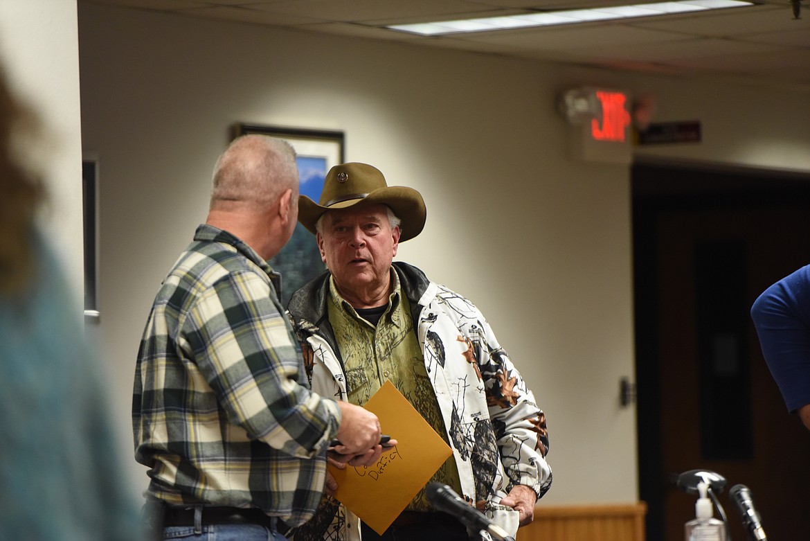 Outgoing City Councilor Rob Dufficy, right, speaks with City Administrator Samuel Sikes at his final meeting as a member of Libby City Council on Dec. 20. (Derrick Perkins/The Western News)