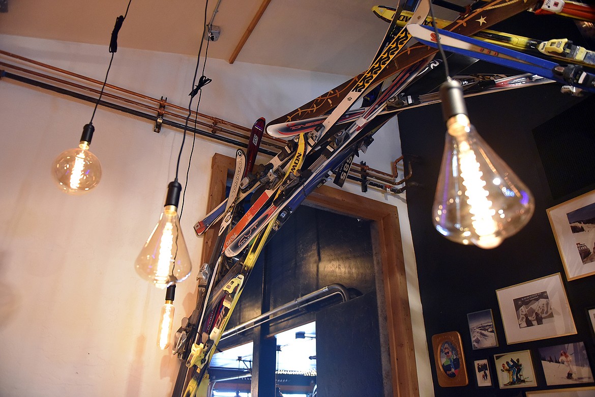 The Stumptown restaurant has a ski theme, which is highlighted in several art installations  built and imagined by owner Sam Dauenhauer. One area features a ski archway with a wall of local Whitefish family ski photos. (Heidi Desch/Whitefish Pilot)