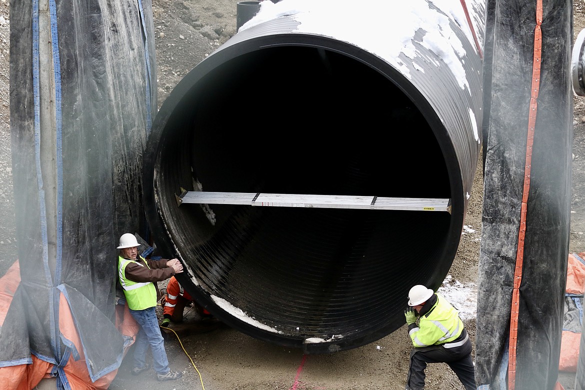 From left, Ron Isbell and Glenn Southerland work to install a new storage tank on Dec. 13, part of the $24 million upgrade by the Hayden Area Regional Sewer Board to meet Spokane River dissolved oxygen total daily maximum load limits standards for 2024. HANNAH NEFF/Press