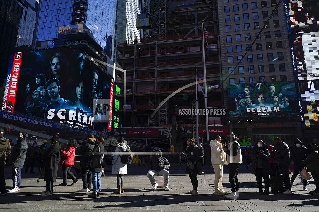 People wait in a long line to get tested for COVID-19 in Times Square, New York, Monday, Dec. 20, 2021. Just a couple of weeks ago, New York City seemed like a relative bright spot in the U.S. coronavirus struggle. Now it's a hot spot, confronting a dizzying spike in cases, a scramble for testing, a quandary over a major event and an exhausting sense of déjà vu. (AP Photo/Seth Wenig)