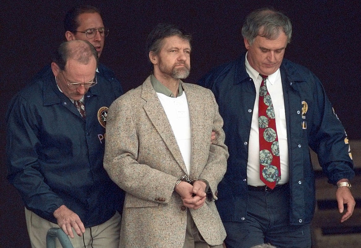 FILE - Theodore Kaczynski looks around as U.S. Marshals prepare to take him down the steps at the federal courthouse to a waiting vehicle on June 21, 1996, in Helena. (AP Photo/Elaine Thompson, File)