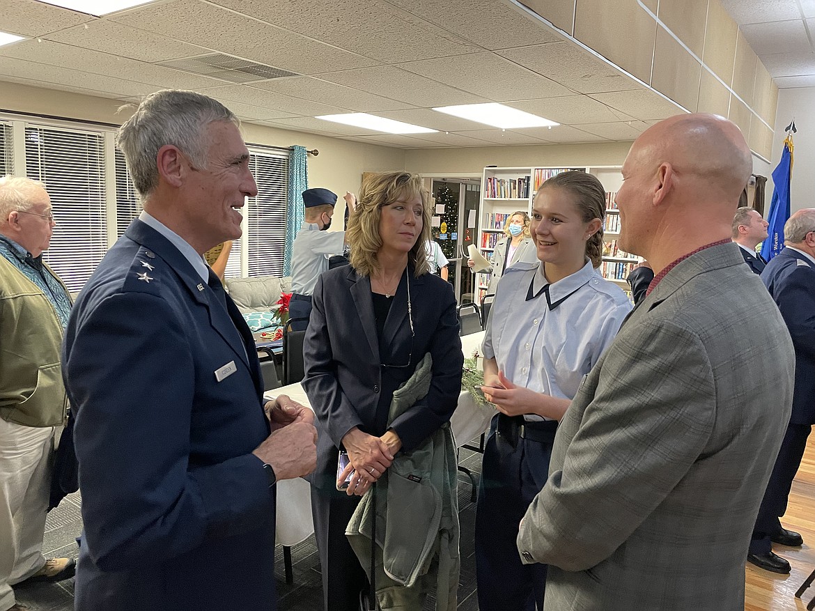 Retired U.S. Air Force Maj. Gen. R. Mike Worden, left, speaks with Kathy Henke, her daughter and newly sworn-in Civil Air Patrol Cadet Meghan, and John Henke, following a banquet Dec. 16 in honor of the patrol’s 80th anniversary.