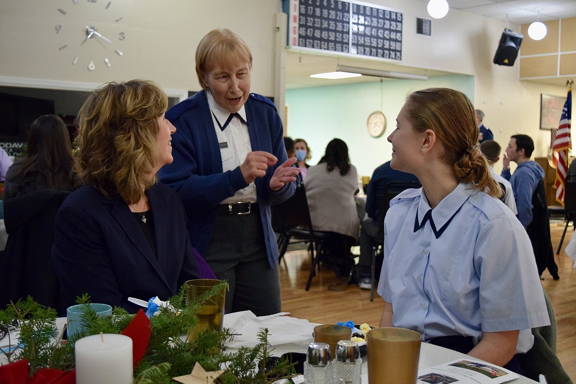 Karen Henke, left, and her daughter, newly sworn-in Civil Air Patrol Cadet Meghan Henke, right, speak with Lt. Col. Kathy Maxwell at a banquet and ceremony Dec. 16 in Ephrata marking the 80th anniversary of the founding of the Civil Air Patrol.